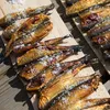 Smoked fish sprinkled with salt on wooden boards. Produktbild-Vorschau