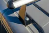 A close-up view of a roof rack mounting bracket attached to a car's roof. Náhľad obrázku produktu
