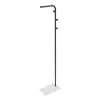 A black metal coat rack with a white rectangular base, shown against a white background. Voir les images du produit