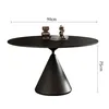 A black round dining table with a conical base, shown with decorative items on top and dimension labels. Produktbild-Vorschau