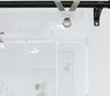 A close-up view of a white sheer curtain with silver butterfly patterns, attached to a black curtain rod with metal clips. Produktbild-Vorschau