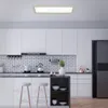 A modern kitchen interior with white cabinets, a subway tile backsplash, and a marble countertop. Produktbild-Vorschau