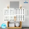 A collection of mirror mounting clips, screws, and wall anchors arranged on a blurred background of a bathroom setting. Produktbild-Vorschau