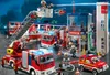 A detailed scene of a Playmobil fire station with multiple vehicles and figures. Produktbild-Vorschau
