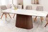 A dining table with chairs in a well-lit room. Produktbild-Vorschau