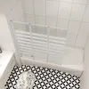 A bathroom with a bathtub and shower screen. Produktbild-Vorschau