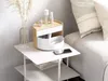 A makeup organizer sits on a bedside table next to a bed. Náhled obrázku produktu