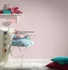 A nursery scene with a crib, toys, and a shelf with baby items. Produktbild-Vorschau