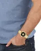 A person's arm wearing a gold watch. Náhľad obrázku produktu