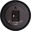 The back of a round wall clock, showing the battery compartment and mounting mechanism. Podgląd zdjęcia produktu