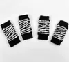 Four dog leg braces with a zebra print pattern are laid out on a white background. Produktbild-Vorschau