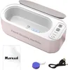 A white ultrasonic cleaning machine with a gray lid, shown with a manual, a contact lens case, and a USB cable. Produktbild-Vorschau