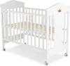 A white baby crib with a wooden slatted base and wheels, shown from a diagonal angle against a white background. Produktbild-Vorschau