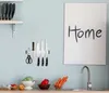 A kitchen scene with a magnetic knife strip mounted on the wall, holding knives and scissors. Below the strip, a countertop displays a colander with lettuce, a bowl with a red pepper, a bowl of carrots, and a sink with a faucet. Náhľad obrázku produktu