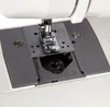 A close-up view of the needle plate and bobbin area of a sewing machine. Podgląd zdjęcia produktu