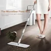 A person is using a microfiber floor mop to clean a wooden floor. A bucket and a potted plant are also visible. Náhľad obrázku produktu
