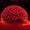 Red net lights draped over a bush at night. Náhled obrázku produktu