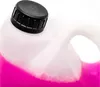 A close-up shot of the top of a plastic container filled with pink liquid and foam. Produktbild-Vorschau