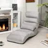 A gray lounge chair is placed in a living room next to a fireplace. Anteprima dell’immagine prodotto