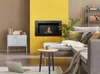 A modern living room with a bio-fireplace, sofa, and coffee table. Produktbild-Vorschau