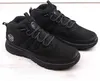 A pair of black mid-top boots. Voir les images du produit