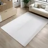 A white rug is laid out on a light wooden floor in a modern living room setting. A sofa with cushions is visible in the background.
