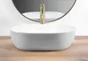 A white vessel sink with a gold faucet on a wooden countertop. Anteprima dell’immagine prodotto
