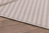 A close-up view of a rug with stripes on a wooden floor. Produktbild-Vorschau