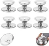 A set of six stainless steel pot lid knobs, with one lid shown separately and a person holding another lid. Produktbild-Vorschau