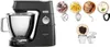 A black Kenwood stand mixer is shown alongside various attachments and food items, suggesting its use in baking and food preparation. Voir les images du produit
