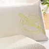 A close-up view of a pillow with embroidered text and a logo. Produktbild-Vorschau