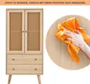 A cabinet with woven doors and drawers is shown next to a hand cleaning a wooden surface with an orange cloth. Anteprima dell’immagine prodotto