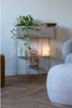 A plant shelf with a planter, vase, and lamp, next to a chair. Náhled obrázku produktu