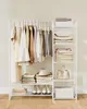 A white garment rack filled with clothes and shelves stocked with folded clothes, a hat, a handbag, and a storage box. Produktbild-Vorschau