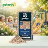 Children playing on a playground with a bag of wood chips in the foreground. Produktbild-Vorschau