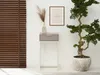 A narrow console table with a drawer, a vase with dried flowers, and a framed picture on a white wall, next to a large potted plant and wooden blinds. Produktbild-Vorschau