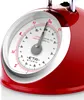 A close-up of a red retro kitchen scale with a white dial and a gray pointer. Náhľad obrázku produktu