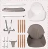 A collection of disassembled parts for a high chair, laid out on a white background. Voir les images du produit