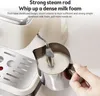 A close-up of a coffee machine's steam wand frothing milk in a metal pitcher. Produktbild-Vorschau