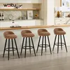 A set of four brown bar stools with black legs are arranged in a kitchen or dining area. Produktbild-Vorschau