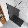 A modern bathroom corner with a black glass shower enclosure and a wooden shelving unit. Produktbild-Vorschau