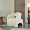 A white boucle armchair is placed in a room with a side table and a floor lamp. Anteprima dell’immagine prodotto