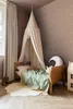 A child's bedroom with a bed, canopy, and decorative items. Podgląd zdjęcia produktu