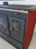 A close-up, angled view of a wood-burning stove with red side panels and a gray front. Produktbild-Vorschau