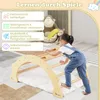 A young child is climbing on a wooden play structure indoors, with stuffed animals in the background. Podgląd zdjęcia produktu