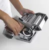 A person's hands are operating a chrome pasta maker. Produktbild-Vorschau