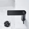 A modern black faucet with a digital temperature display is shown over a sink with water running into the drain. Podgląd zdjęcia produktu