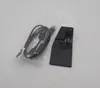 A black scanner accessory and a USB cable in a plastic bag are placed on a white background. Produktbild-Vorschau