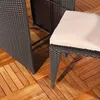 A close-up view of outdoor furniture, specifically a dark rattan chair with a beige cushion, placed on a wooden deck. Anteprima dell’immagine prodotto
