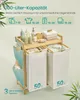 A bamboo laundry basket with two compartments and a top shelf for storage, shown with various toiletries and folded towels. Produktbild-Vorschau